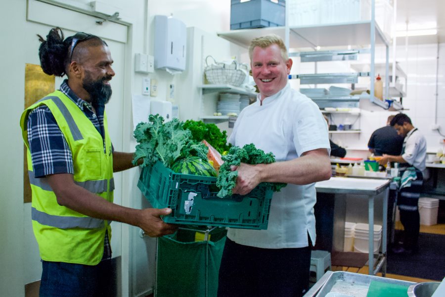 Sanjay Dayal making a delivery to Shaun Clouston of Logan Brown